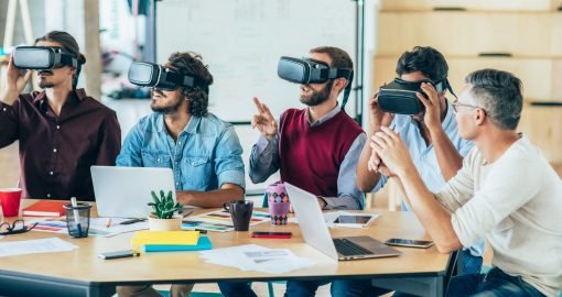 Modern business people using virtual reality headset at the office